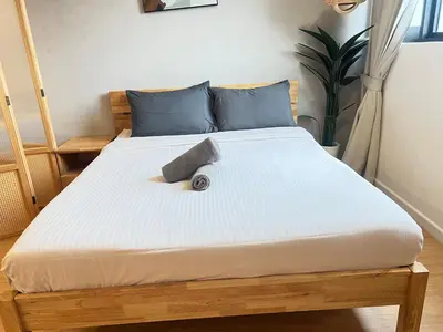 a bed in a room with a white mattress at Chambers Auroa Luxury Suites KLCC in Kuala Lumpur