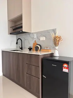 a kitchen with a black refrigerator and a counter at Vista Residence Sentul in Kuala Lumpur