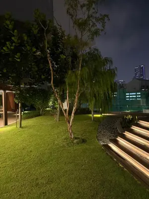 a park with a bench and a tree at night at Residensi Akson Bukit Bintang Axon nearby Pavilion TRX in Kuala Lumpur