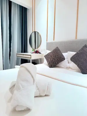 a bedroom with two beds with white sheets and a mirror at Residensi Akson Bukit Bintang Axon nearby Pavilion TRX in Kuala Lumpur