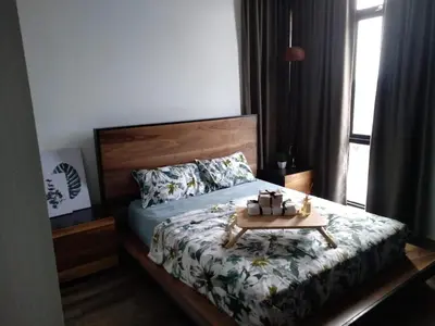 a bedroom with a bed with a table on it at Spacious 2 bedrooms 10 mins to Bukit Bintang in Kuala Lumpur