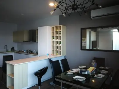 a kitchen with a counter and a table and a mirror at Spacious 2 bedrooms 10 mins to Bukit Bintang in Kuala Lumpur