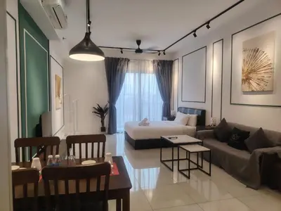 a living room with a couch and a bed at Chambers Skypool KLCC in Kuala Lumpur