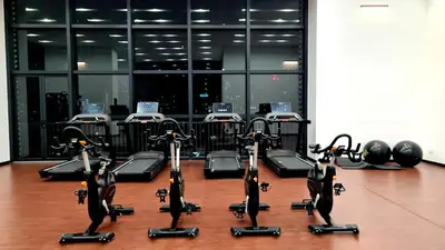 a gym with rows of exercise bikes on the floor at Chambers Skypool KLCC in Kuala Lumpur