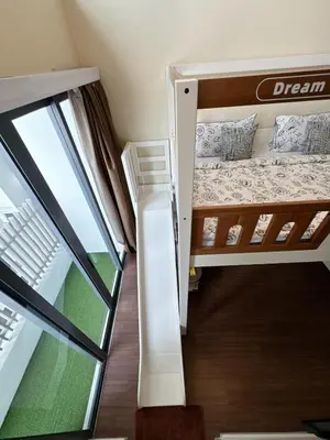 a small room with a bunk bed and a window at INFINITUM suites KLCC , infinity pool 360 view in Kuala Lumpur