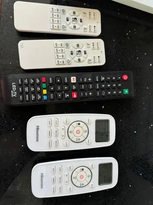 a group of four remote controls sitting on a table at INFINITUM suites KLCC , infinity pool 360 view in Kuala Lumpur