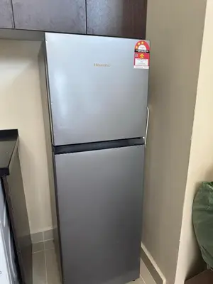 a refrigerator in a kitchen with a sign on it at INFINITUM suites KLCC , infinity pool 360 view in Kuala Lumpur