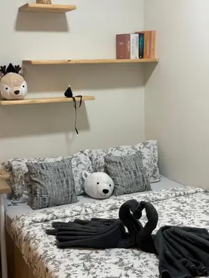 a bedroom with a bed with stuffed animals on it at INFINITUM suites KLCC , infinity pool 360 view in Kuala Lumpur
