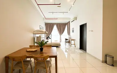 a dining room and living room with a table and chairs at 3 Towers Jln Ampang by Airhost in Kuala Lumpur