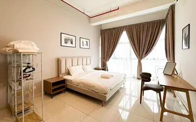 a bedroom with a bed and a desk and a window at 3 Towers Jln Ampang by Airhost in Kuala Lumpur
