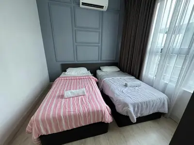two beds sitting next to each other in a room at Comfy Arte Plus Ampang KL City 8 Pax-3BR-2CP in Kuala Lumpur
