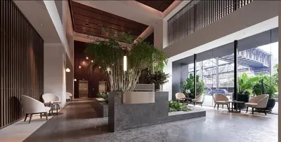 a lobby with chairs and plants in a building at The Establishment Bangsar #26 by Ouki in Kuala Lumpur