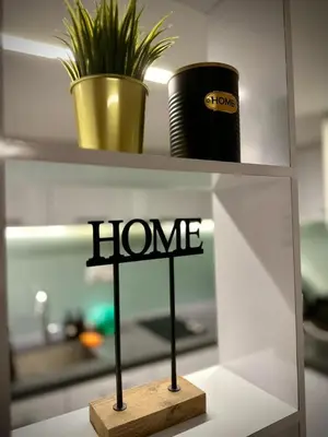a shelf with a sign that says home on it at The Establishment Bangsar #26 by Ouki in Kuala Lumpur