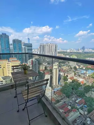 a bench on a balcony with a view of a city at The Establishment Bangsar #26 by Ouki in Kuala Lumpur