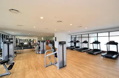a gym with a bunch of treadmills and machines at The Establishment Bangsar #26 by Ouki in Kuala Lumpur
