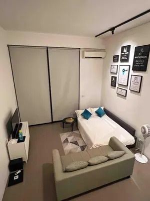 a living room with a bed and a couch at The Establishment Bangsar #26 by Ouki in Kuala Lumpur