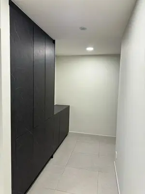 a room with black cabinets and a white wall at The Atrium at Jalan Ampang by OKBnB - Classy 3Bedroom Family Suite nearby KLCC , TRX and Pavilion KL in Kuala Lumpur