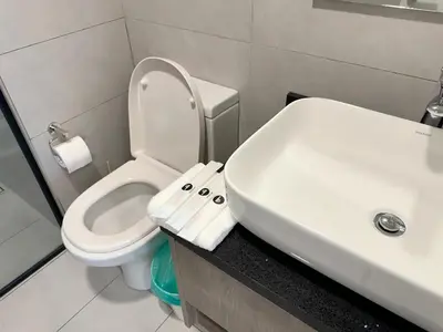 a bathroom with a white toilet and a sink at The Atrium at Jalan Ampang by OKBnB - Classy 3Bedroom Family Suite nearby KLCC , TRX and Pavilion KL in Kuala Lumpur