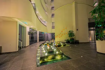 a lobby with a fountain in the middle of a building at The Atrium at Jalan Ampang by OKBnB - Classy 3Bedroom Family Suite nearby KLCC , TRX and Pavilion KL in Kuala Lumpur