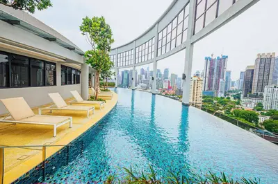 a hotel swimming pool with a view of a city at The Atrium at Jalan Ampang by OKBnB - Classy 3Bedroom Family Suite nearby KLCC , TRX and Pavilion KL in Kuala Lumpur