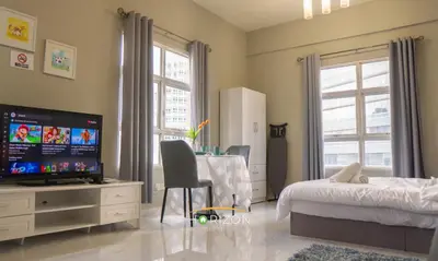 a bedroom with a bed and a desk with a television at MayTower by Horizon Homes in Kuala Lumpur