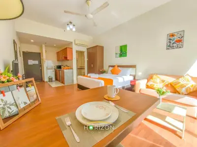 a large living room with a bed and a table at MayTower by Horizon Homes in Kuala Lumpur