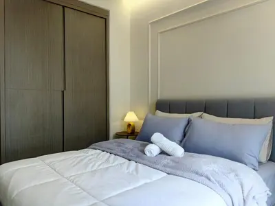 a bed with a stuffed animal on top of it at TRX Agile Bukit Bintang Boutique 2 Bedroom and 1 Living Room Suites in Kuala Lumpur