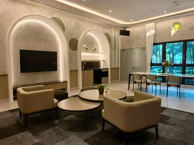 a living room with a tv and a table and chairs at TRX Agile Bukit Bintang Boutique 2 Bedroom and 1 Living Room Suites in Kuala Lumpur