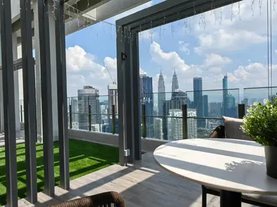 a balcony with a table and a view of the city at TRX Agile Bukit Bintang Boutique 2 Bedroom and 1 Living Room Suites in Kuala Lumpur