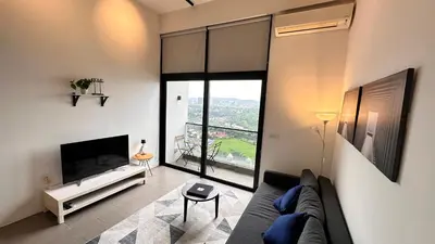 a living room with a couch and a large window at The Establishment Bangsar #23a by Ouki in Kuala Lumpur