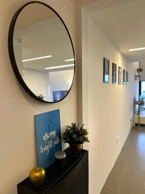 a hallway with a mirror and a table with a plant at The Establishment Bangsar #23a by Ouki in Kuala Lumpur