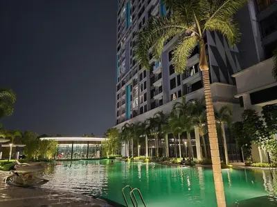 a swimming pool with a palm tree in front of a building at Trion Kuala Lumpur For KLCC view BLOCK C in Kuala Lumpur