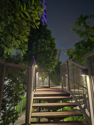 a wooden walkway with a gate at night at Trion Kuala Lumpur For KLCC view BLOCK C in Kuala Lumpur