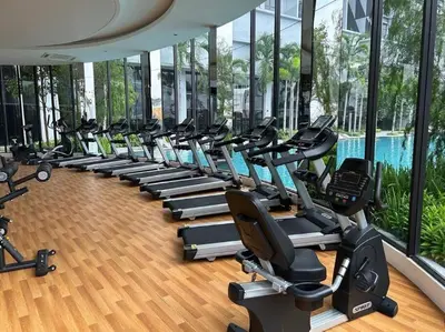 a gym with a row of treadmills and exercise bikes at Trion Kuala Lumpur For KLCC view BLOCK C in Kuala Lumpur