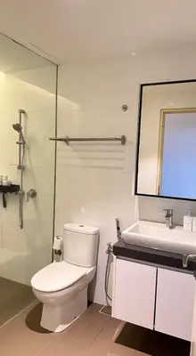 a bathroom with a toilet and a sink and a mirror at The Establishment Bangsar #2216 by Ouki in Kuala Lumpur