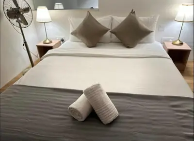 a bedroom with a bed with two towels on it at The Establishment Bangsar #2216 by Ouki in Kuala Lumpur