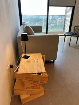 a table with a lamp on top of boxes on the floor at The Establishment Bangsar #29 by Ouki in Kuala Lumpur