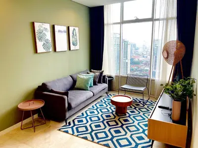 a living room with a couch and a large window at Ludy House in Kuala Lumpur