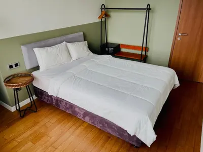 a large bed in a bedroom with a wooden floor at Ludy House in Kuala Lumpur