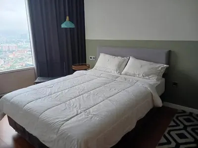 a bedroom with a white bed with a large window at Ludy House in Kuala Lumpur