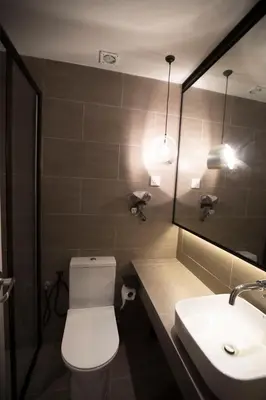a bathroom with a toilet and a sink and a mirror at M1- room w planter box in Kuala Lumpur