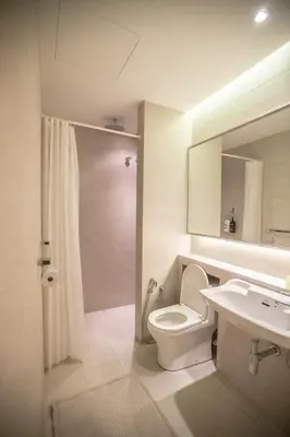 a bathroom with a toilet and a sink and a mirror at M1- room w planter box in Kuala Lumpur