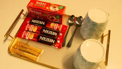 a pile of cinnamon sticks and a pair of spoons and two cups at Axon Residences KLCC - Premium Suites in Kuala Lumpur