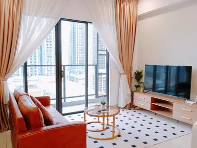 a living room with a couch and a tv and a table at TRION Luxury City Suites Near KLCC & TRX in Kuala Lumpur