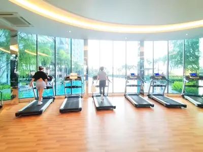two women running on treadmills in a gym at TRION Luxury City Suites Near KLCC & TRX in Kuala Lumpur
