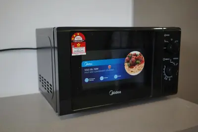 a microwave with a pizza inside of it at Rivera City, KL Sentral Studio Apartment in Kuala Lumpur
