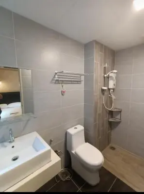 a bathroom with a white toilet and a sink at Arte plus in Ampang