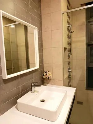 a bathroom with a white sink and a mirror at Robertson Suites At Bukit Bintang Kuala Lumpur in Kuala Lumpur