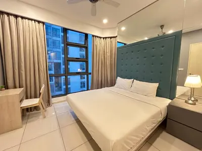 a bedroom with a bed and a desk and a window at Robertson Suites At Bukit Bintang Kuala Lumpur in Kuala Lumpur