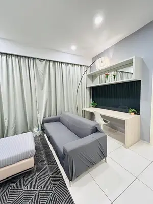 a living room with a couch and a desk at Robertson Suites At Bukit Bintang Kuala Lumpur in Kuala Lumpur